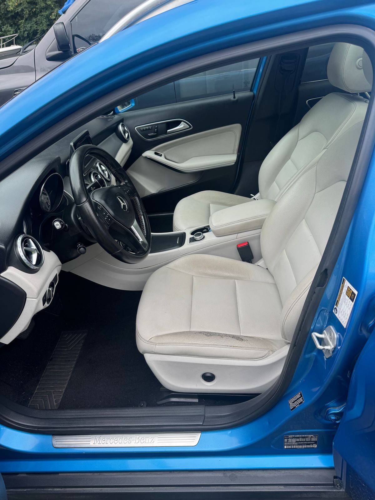 Mercedes-Benz cream leather driver seat before detailing, showing dark grime on the bolster and cushion.